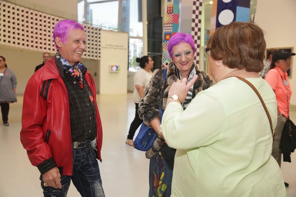 Artist Duaiv and his wife Magella greeting a Park West Gallery guest at YAMA (Photo by Shooka Cohen)